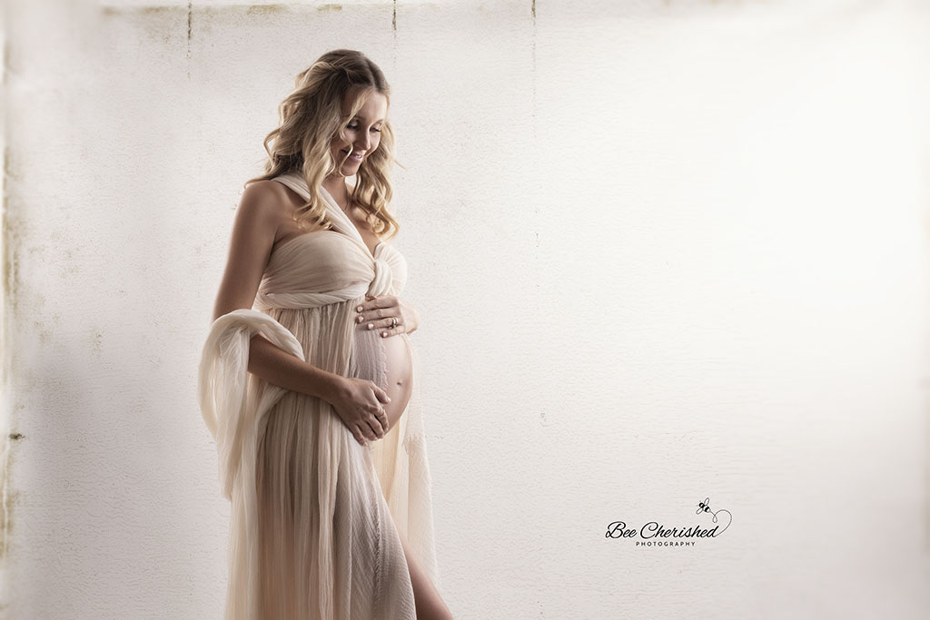 Boho style maternity photography in studio wearing dreamy neutrals